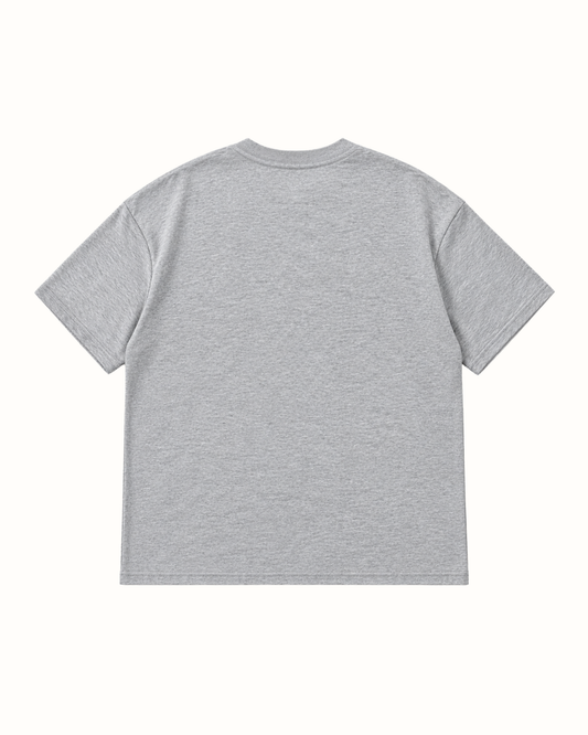 Plain back of the light grey marl YTHEB appliqué T-shirt, showing the dropped shoulders and ribbed crew neck.