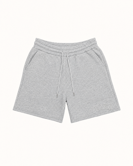 Light gray heathered sweat shorts with a white drawstring and a tonal embroidered logo on the lower left leg, displayed flat against a solid off-white background.