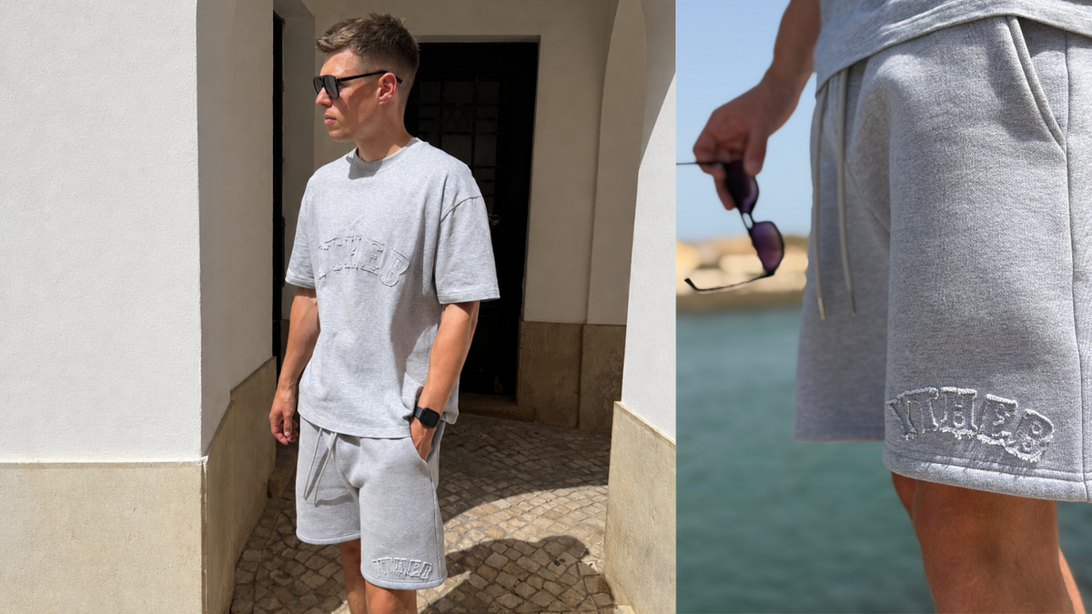 Man wearing a grey marl YTHEB tee with tonal arc lettering and matching grey shorts